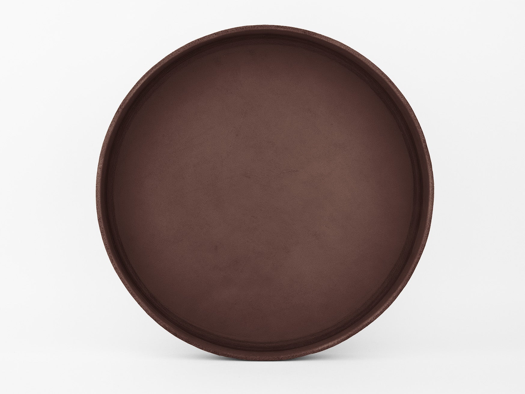 A large, round, empty brown tray with a slightly raised edge, placed against a plain white background.
