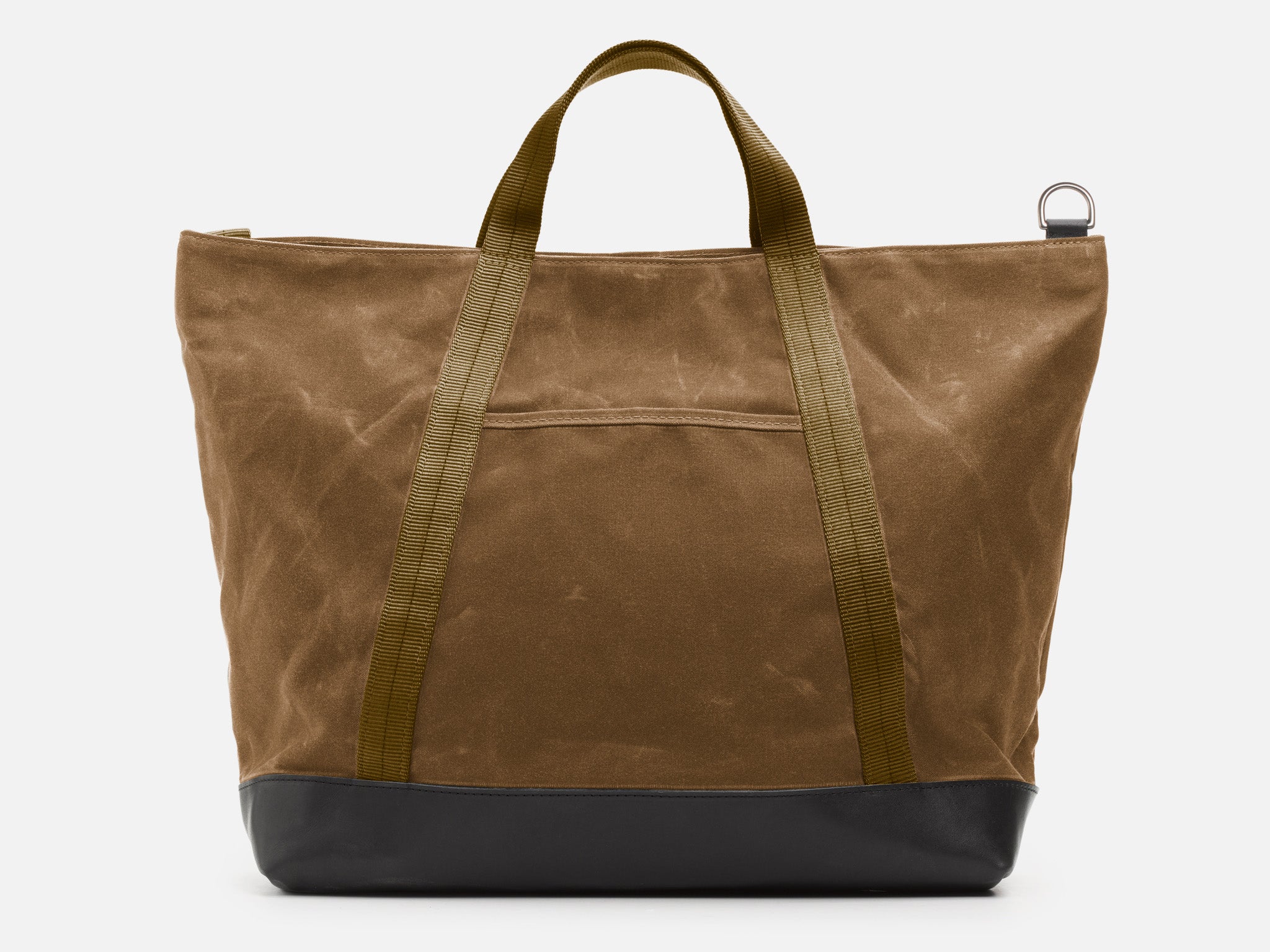 A back view of an brush brown waxed canvas tote bag with 1" nylon brush brown handles with pocket between the handles, and a black leather bottom, set against a plain white background.