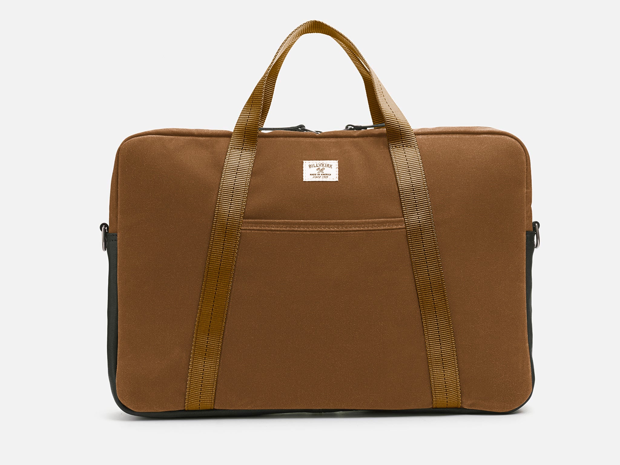 Front View of Brush Brown waxed canvas laptop briefcase bag with tan shoulder strap, a small front pocket, and a black leather bottom detail against a plain background.