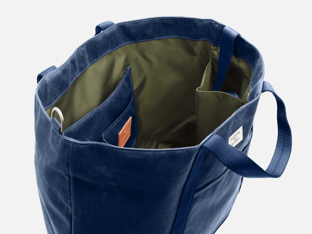 Blue tote bag with a visible brand logo on a white background