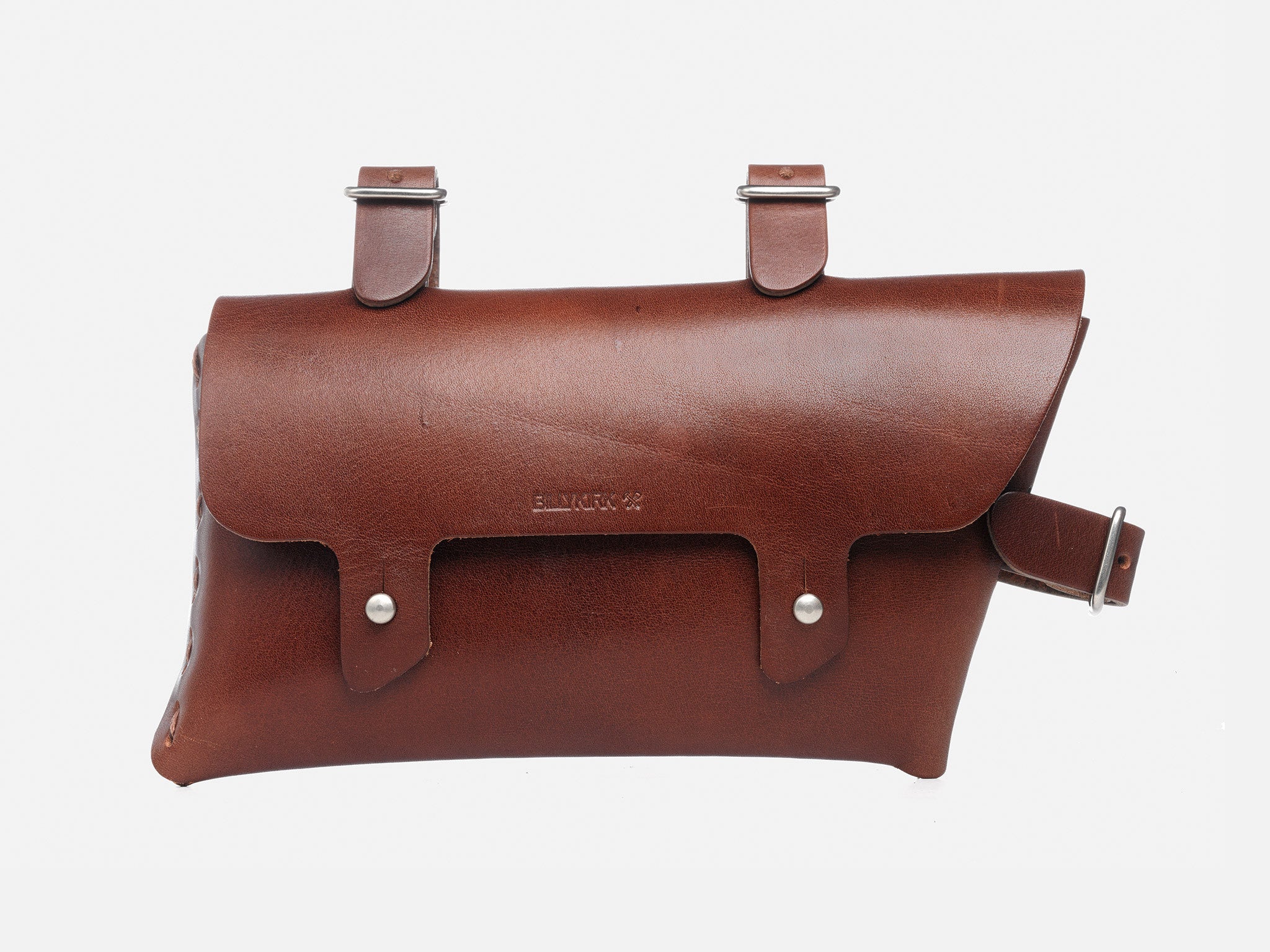 A brown leather bicycle saddle bag with two straps and buckles for attachment, silver rivets, and a flap closure secured by a belt-style buckle.

